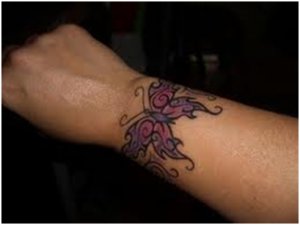 Tattoo on wrist of a pretty butterfly.