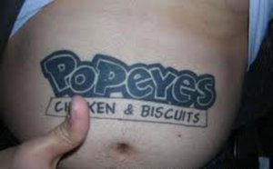 Belly tattoo of Popeyes Chicken endorsement