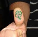 Tattoo of Four leaf clover on thumb.