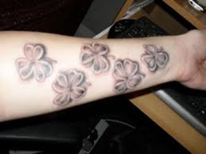 This person has it all. An arm tattoo with the lucky four leaf clover and the godly three leaf clover shamrock