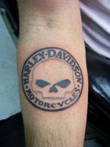 Harley davidson skull tattoo on a male forearm