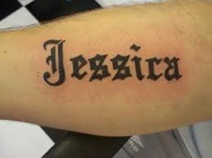 Tattoo on the arm in old english letters of the name Jessica