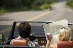 This is an image of a couple going on a rad trip looking at a map