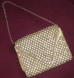 This is an image of a 1930s gold alligator purse