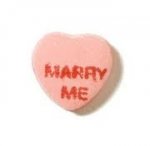 This is an image of a candy heart that says marry me on it