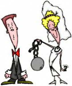 Humorous image of a bride holding the ball and chain with a big smile, and the groom looking rather frightened and perplexed