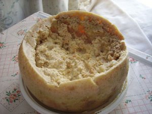 This is an image of Casu Marzu from Italy. It is rotting cheese with bug larvae
