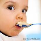 This is an image of a little baby eating cereal
