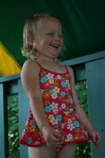 This is an image of a little girl laughing