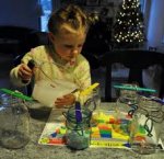 A child playing with an at home science kit.