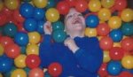 This is an image of a child in a ball pit